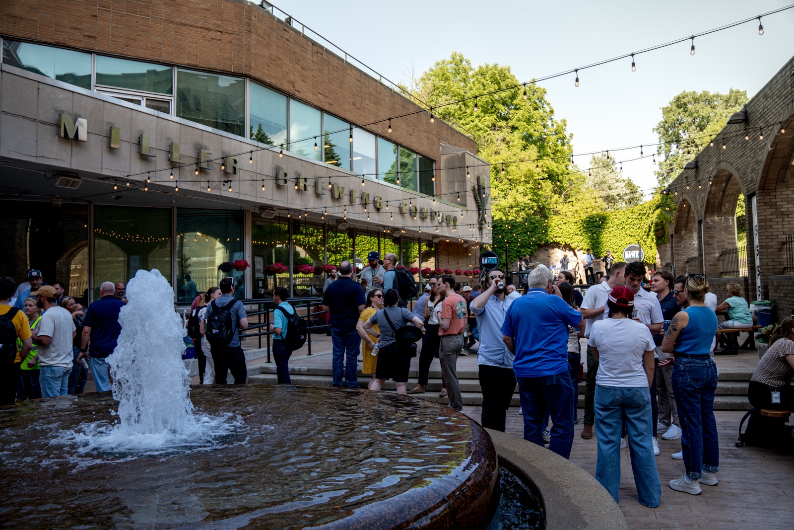 An outdoor gathering photographed beside a fountain